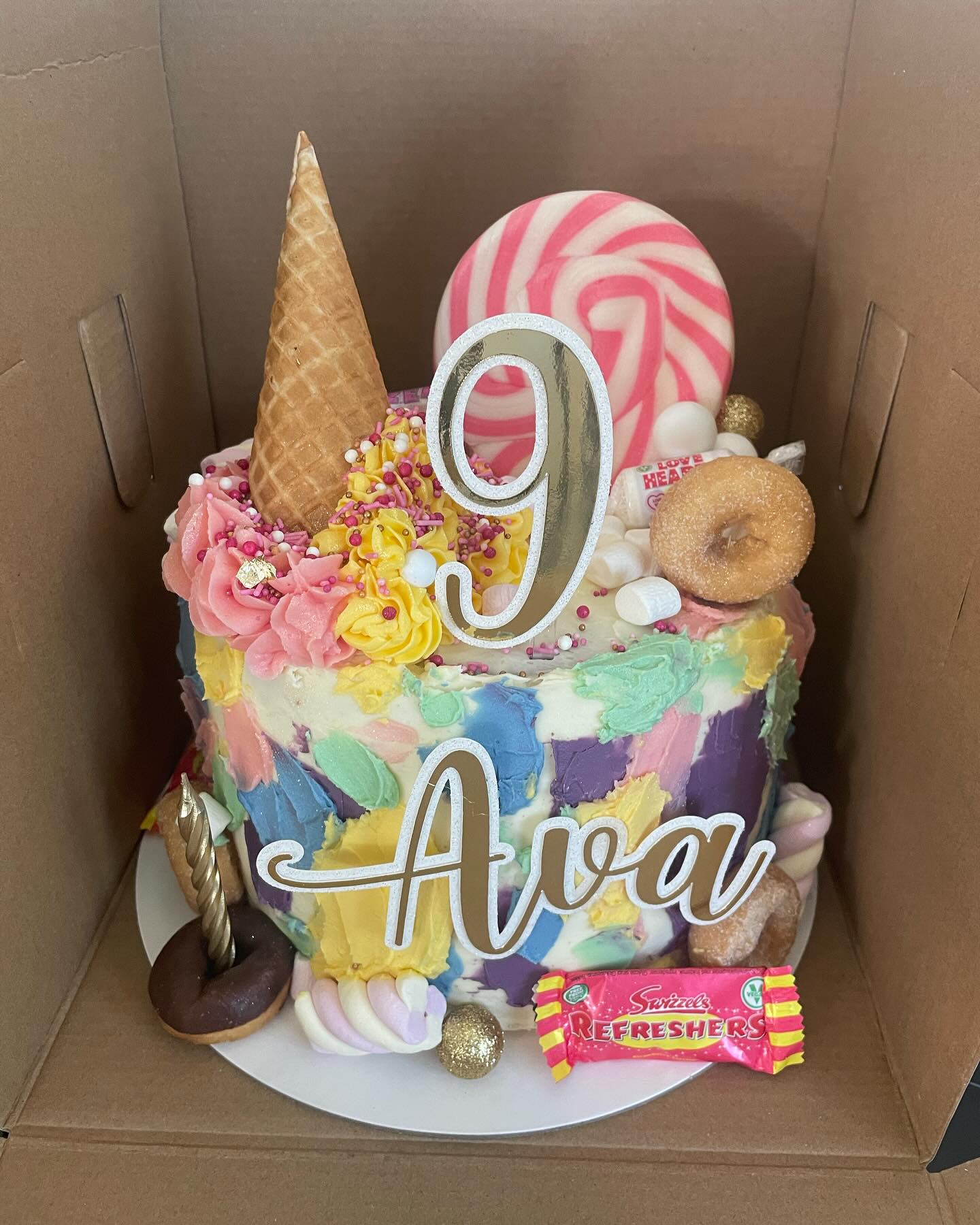 Candy-themed birthday cake with Ava topper from Sweet Sentiments